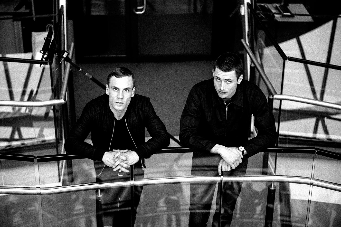 Lachlan Nieboer and Nick Blood leaning on a bannister