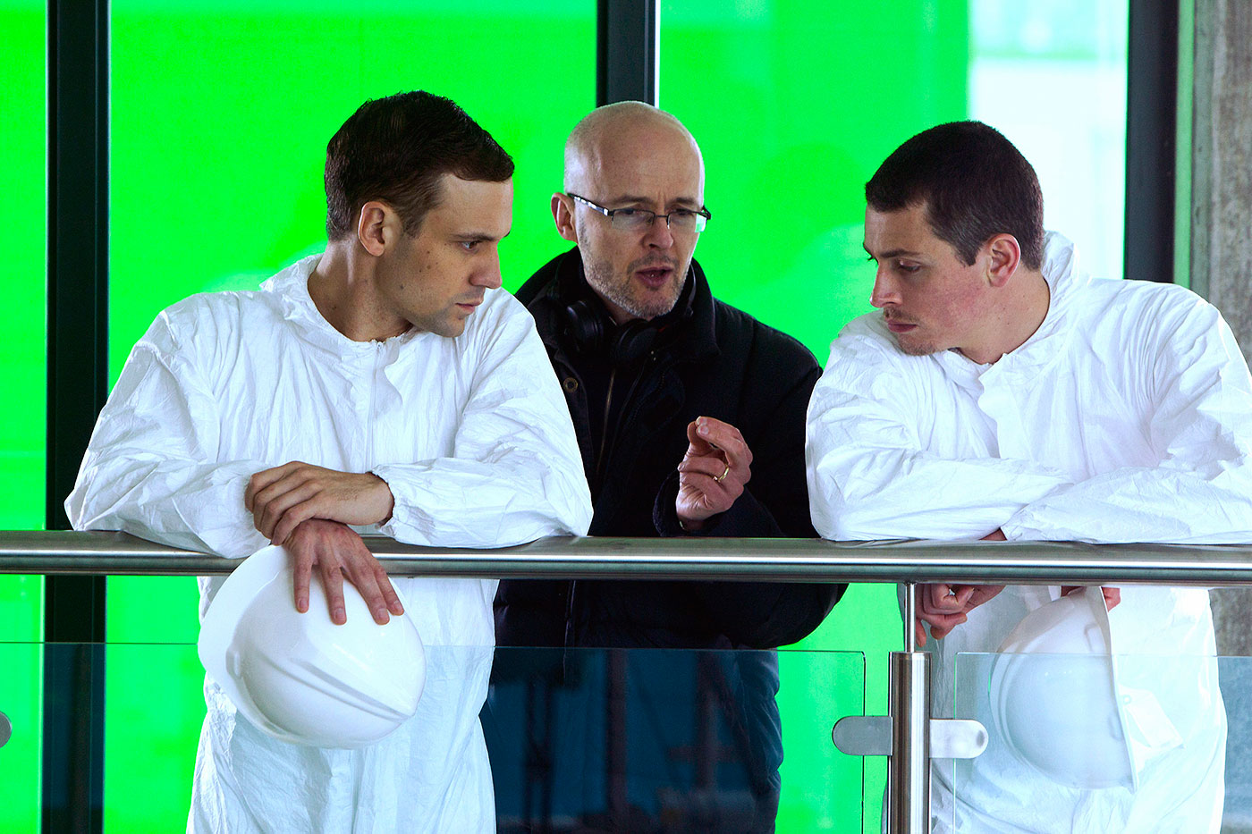 Lachlan and Nick are instructed by Simon in front of a green screen